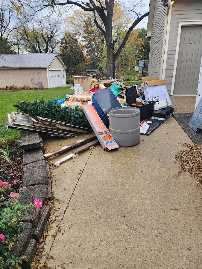 Dumpster being loaded with debris for 3 Yard Dumpster Rental in Hazelwood